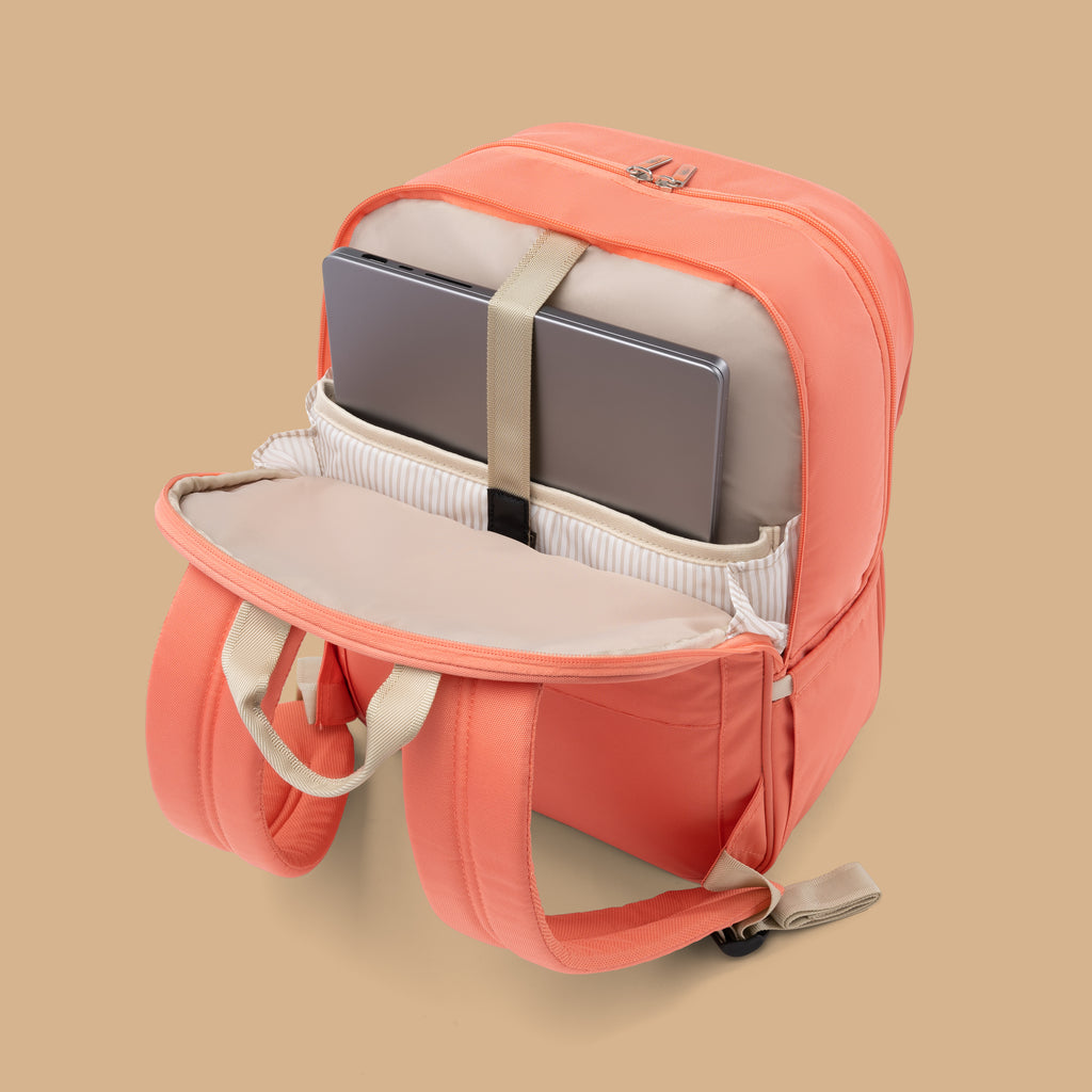 open coral orange daytrip backpack with laptop in it