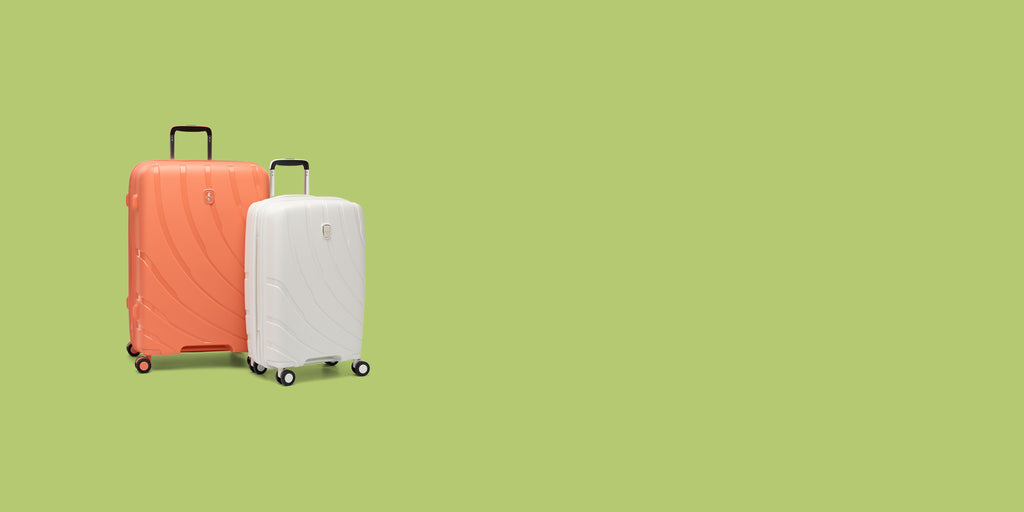 pair of coral orange and shell white luggage