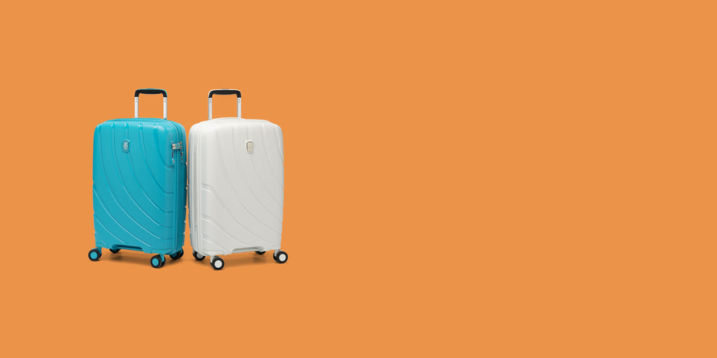 pair of surf teal and shell white luggage