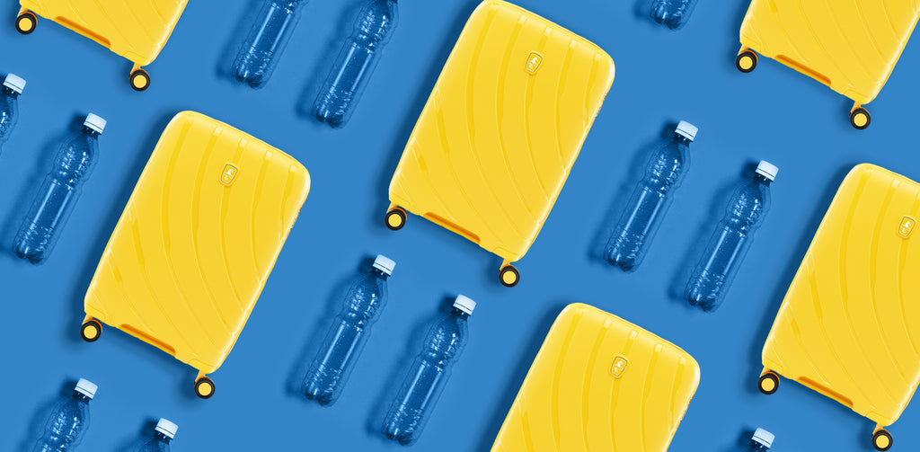 atlantic luggage with empty water bottles on blue background