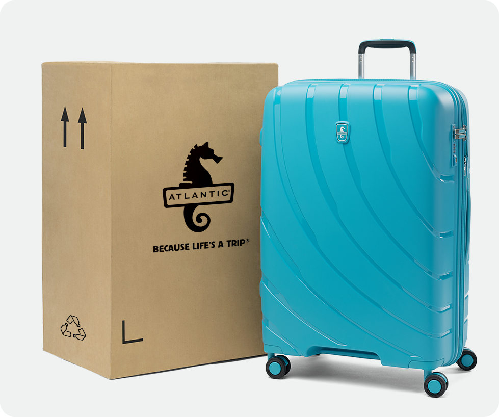surf teal luggage next to cardboard box